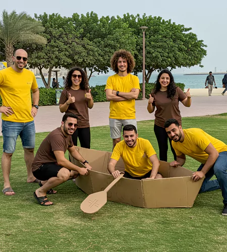 A team proudly posing with their handmade cardboard boat during the Float or Fail Challenge, showcasing creativity, teamwork, and problem-solving
