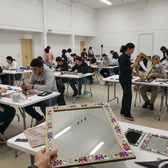 Creative art workshop with embroidery hoops and colourful threads arranged on long tables for participants at MRM Events.