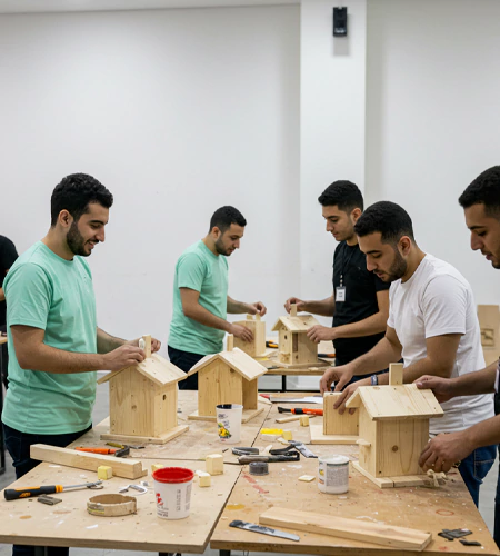 Participants build wooden birdhouses together during a birdhouse builders team-building challenge organised by MRM Events.