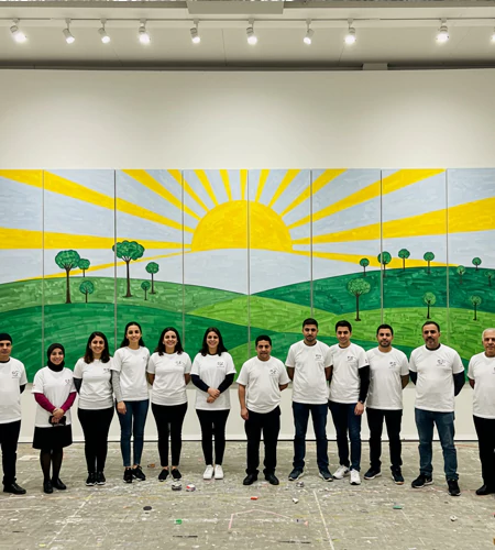 Participants collaborate on building a detailed miniature landscape using model buildings and trees as part of MRM Events' Masterpiece team challenge.