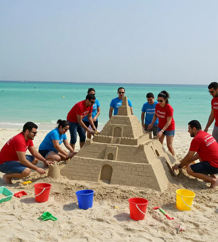 Sand sculpting team-building challenge featuring sack race competitions on a grassy field, encouraging teamwork at MRM Events.