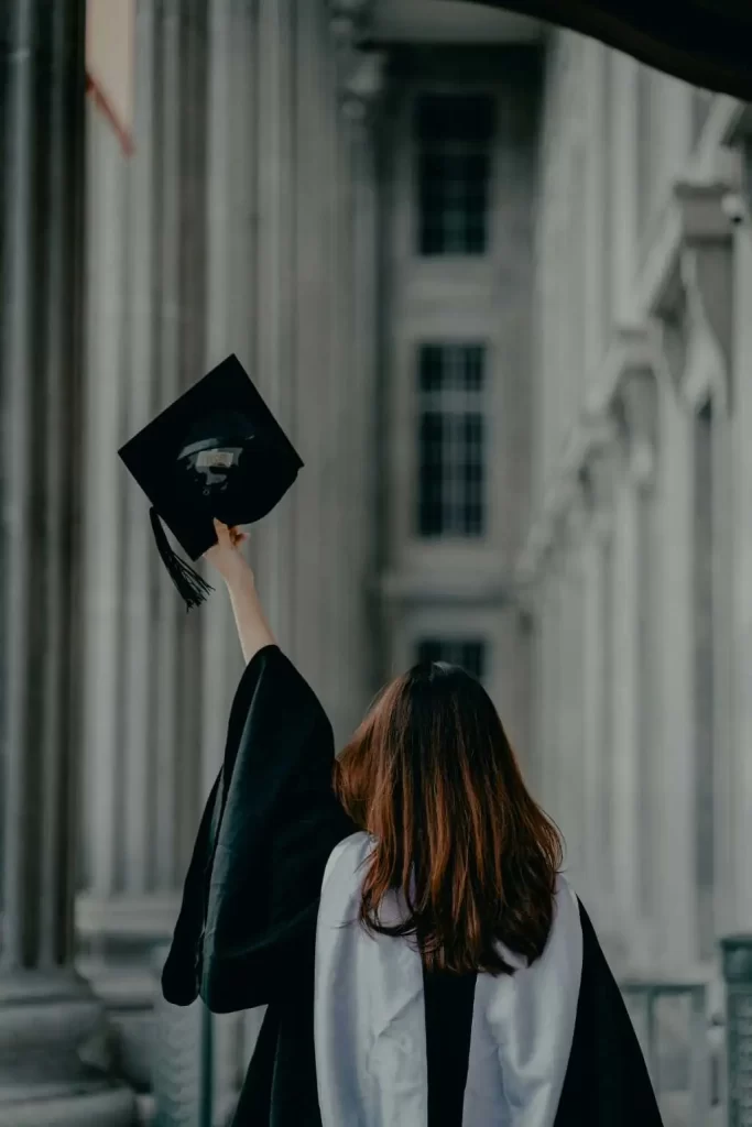 Graduate raising her cap in celebration, representing MRM Events' academic ceremonies.