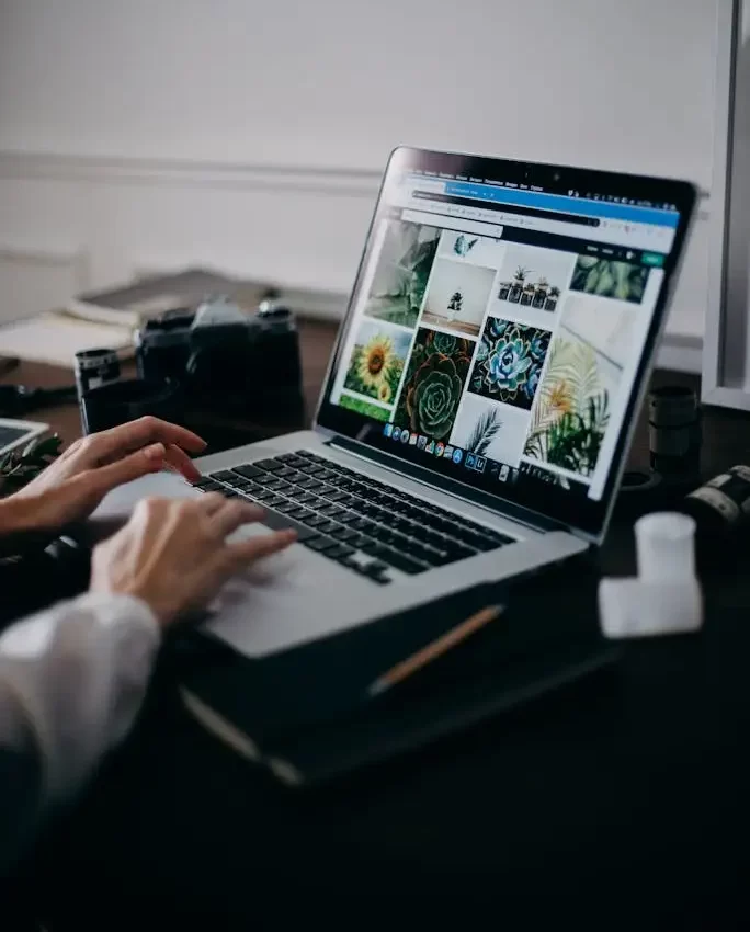 Creative workspace with a MacBook Pro, stylus and design sketches, representing MRM Events' content creation process.