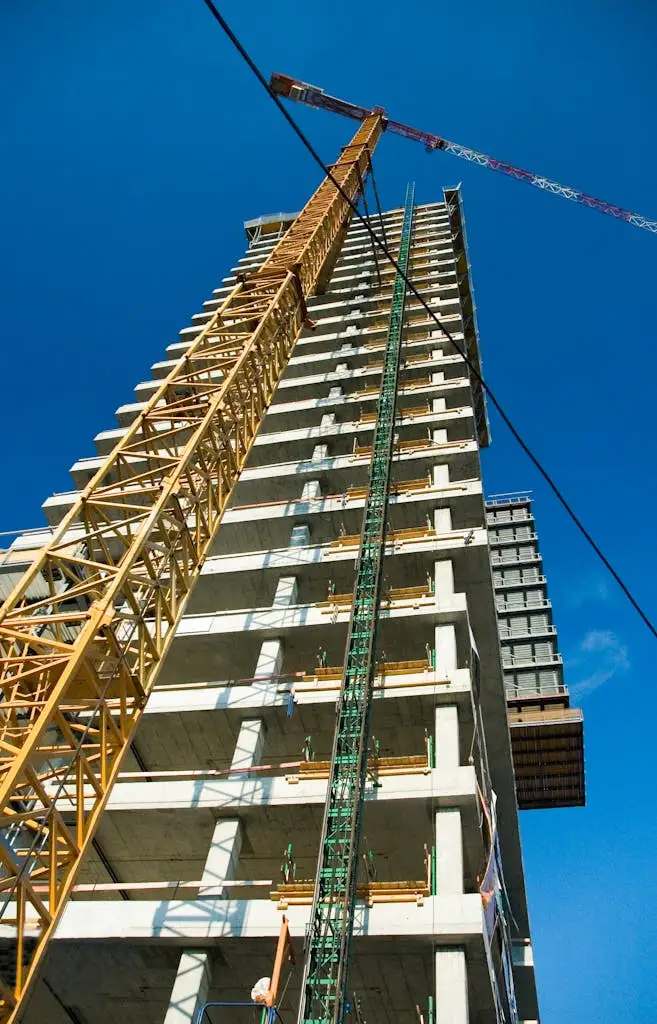 Construction site with crane and skyscrapers under a blue sky, representing large-scale venue setups coordinated by MRM Events.