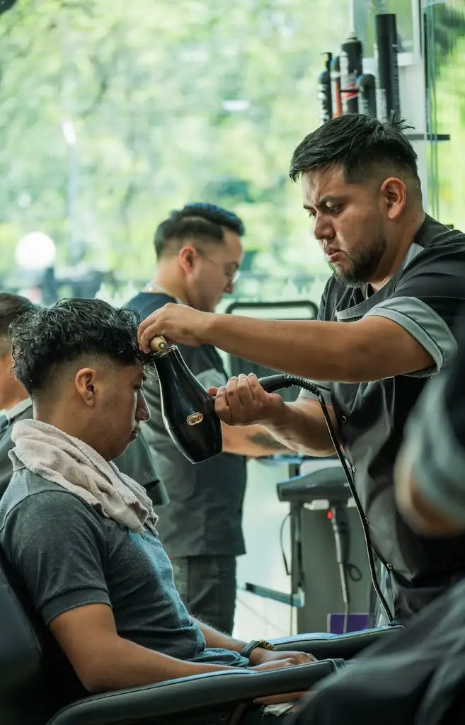 Barber cutting a client's hair in a salon, depicting lifestyle events and grooming services at MRM Events.
