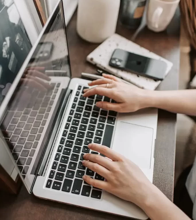 Two professional women discussing charts and graphs at a desk with a laptop, highlighting strategic event planning sessions at MRM Events.