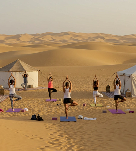 Corporate participants practicing yoga in Dubai desert retreat, part of wellness workshops in Dubai for stress relief and team well-being at corporate events.