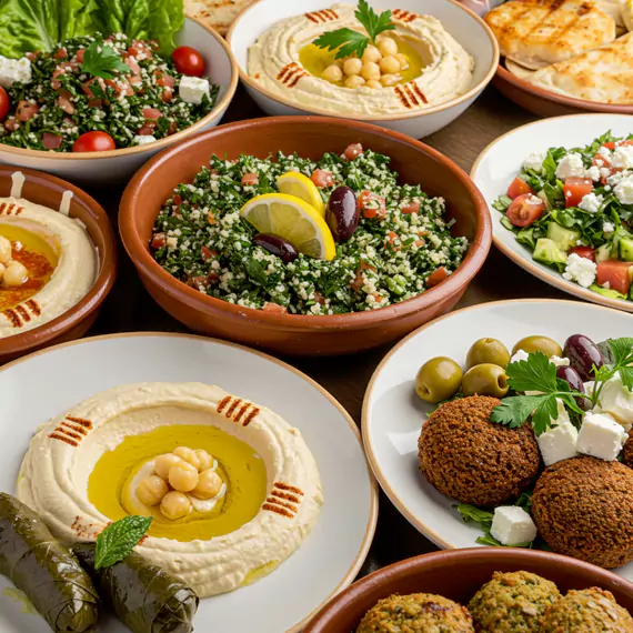 A selection of Mediterranean dishes for business meeting catering, featuring hummus, tabbouleh, falafel, and fresh salads, ideal for corporate catering services in Dubai.