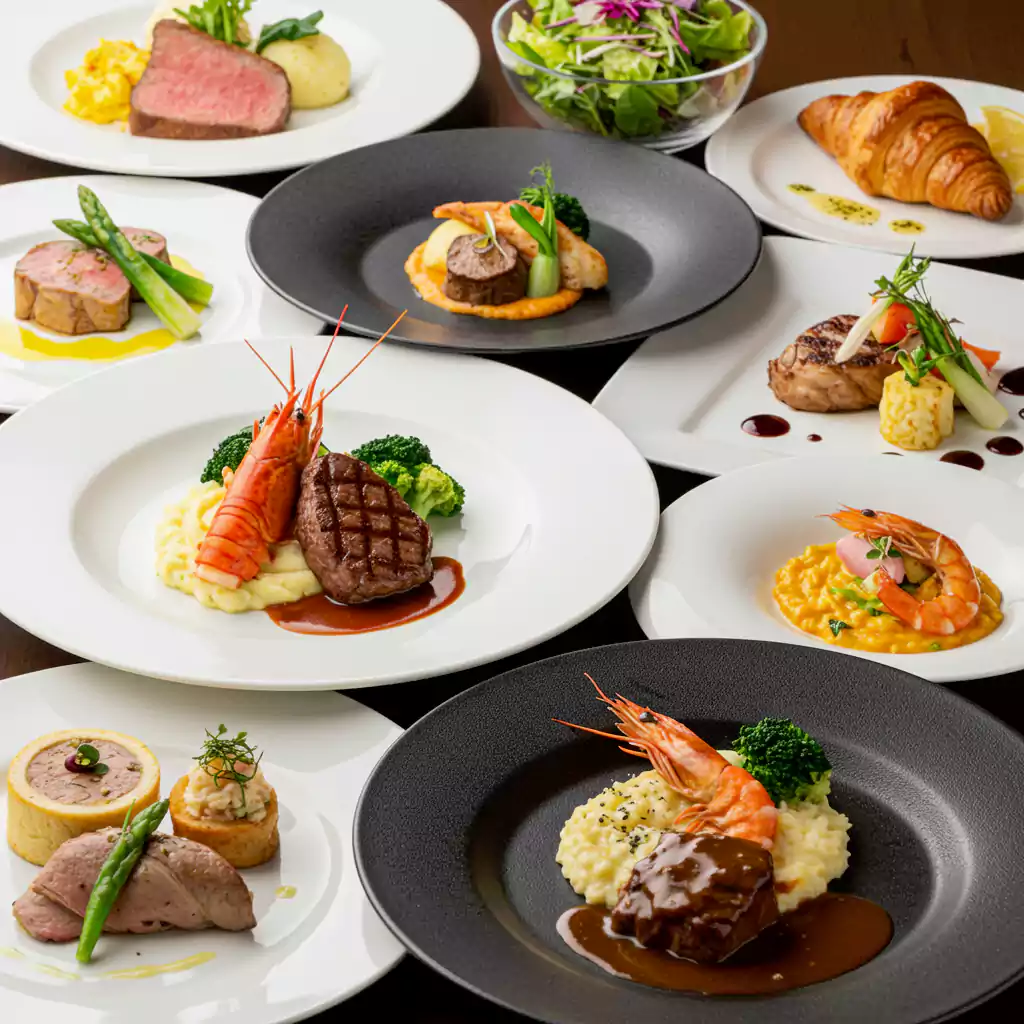 "Fine dining plates for business meeting catering, with steak, seafood, and risotto, perfect for high-end corporate events in Dubai. "