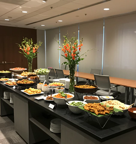 A South Asian buffet for business meeting catering with savory snacks, curries, and salads, ideal for corporate catering in Dubai.