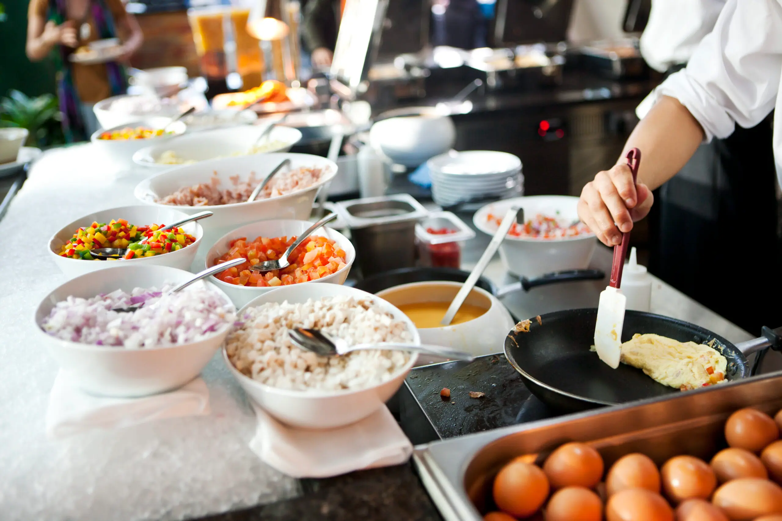 A breakfast buffet for business meeting catering with pastries, pancakes, fruits, and eggs, ideal for corporate catering in Dubai