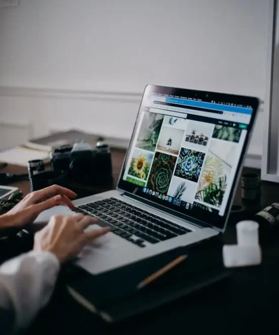 Creative workspace with a MacBook Pro, stylus and design sketches, representing MRM Events' content creation process.