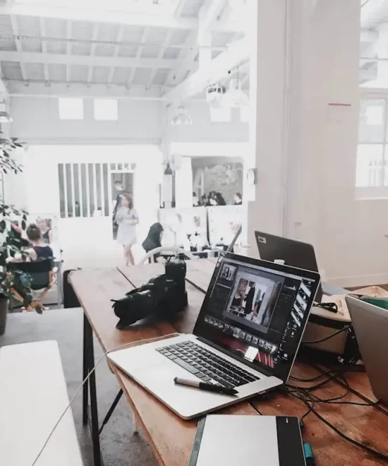 Modern workspace with laptop, DSLR camera and drawing tablet, reflecting MRM Events' creative planning environment.