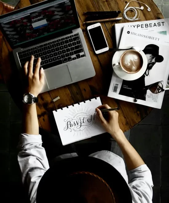 Photographer editing photos on a laptop with memory cards and lens, reflecting MRM Events' professional photo and video post-production.