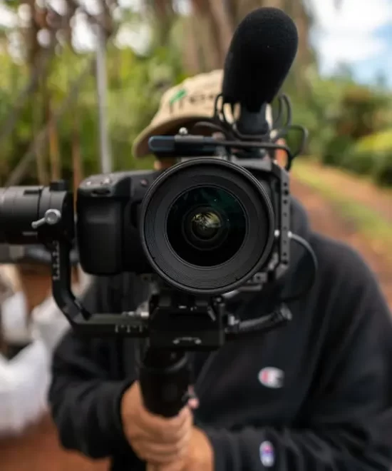 Videographer with camera and lighting rig capturing moments, representing professional photography services by MRM Events.